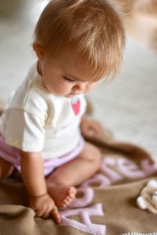 Little Girl Playing On Personalized Blanket